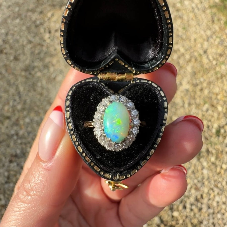 Opal and Diamond Cluster Ring Edwardian c1910 Australian oval opal 9.5mm x 7mm surrounded by 0.54cts of 8 old cut diamonds set in platinum and 18ct yellow gold. Australian circa 1910